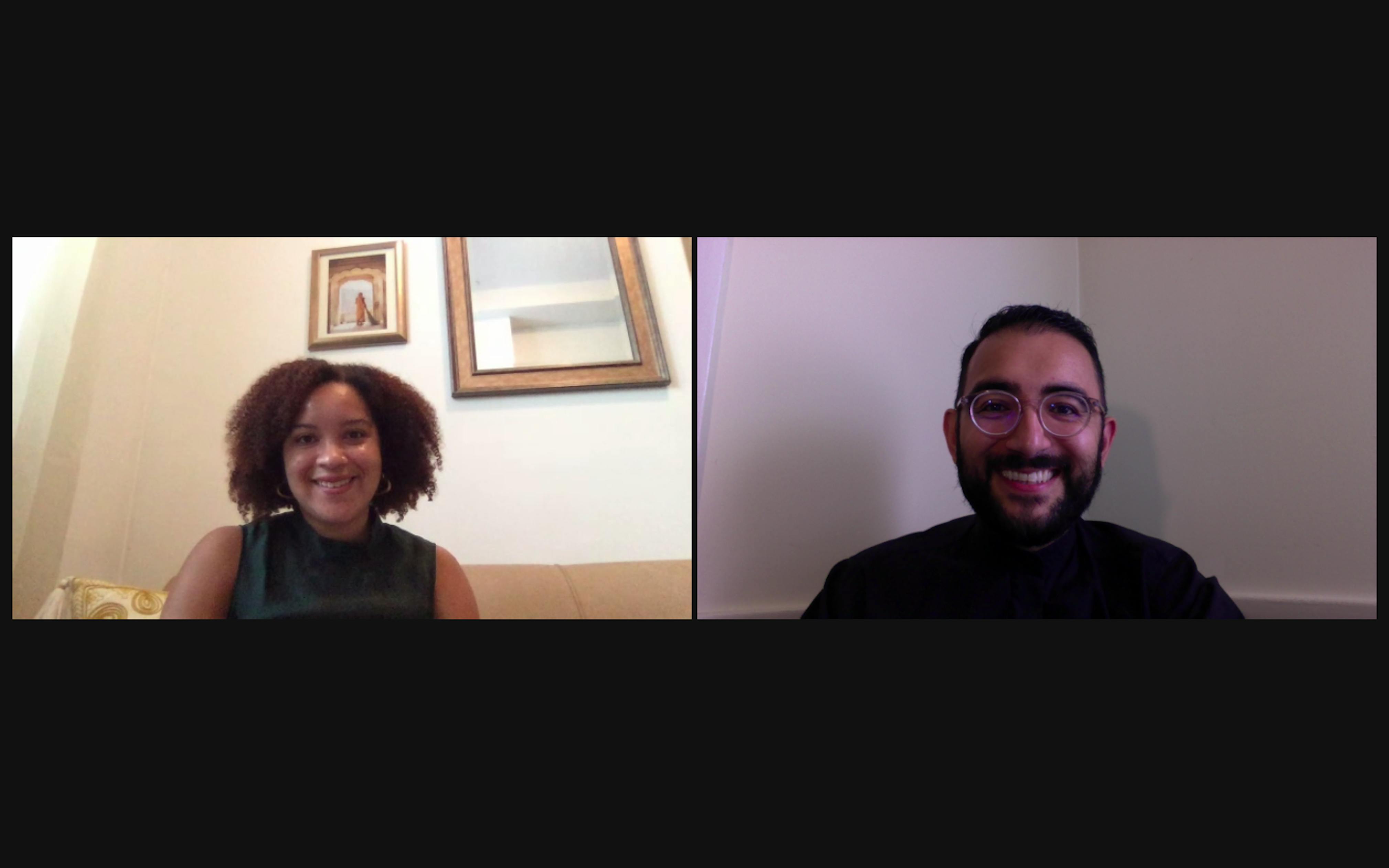 A screenshot of a Black woman in a tank top talking to a man in glasses.