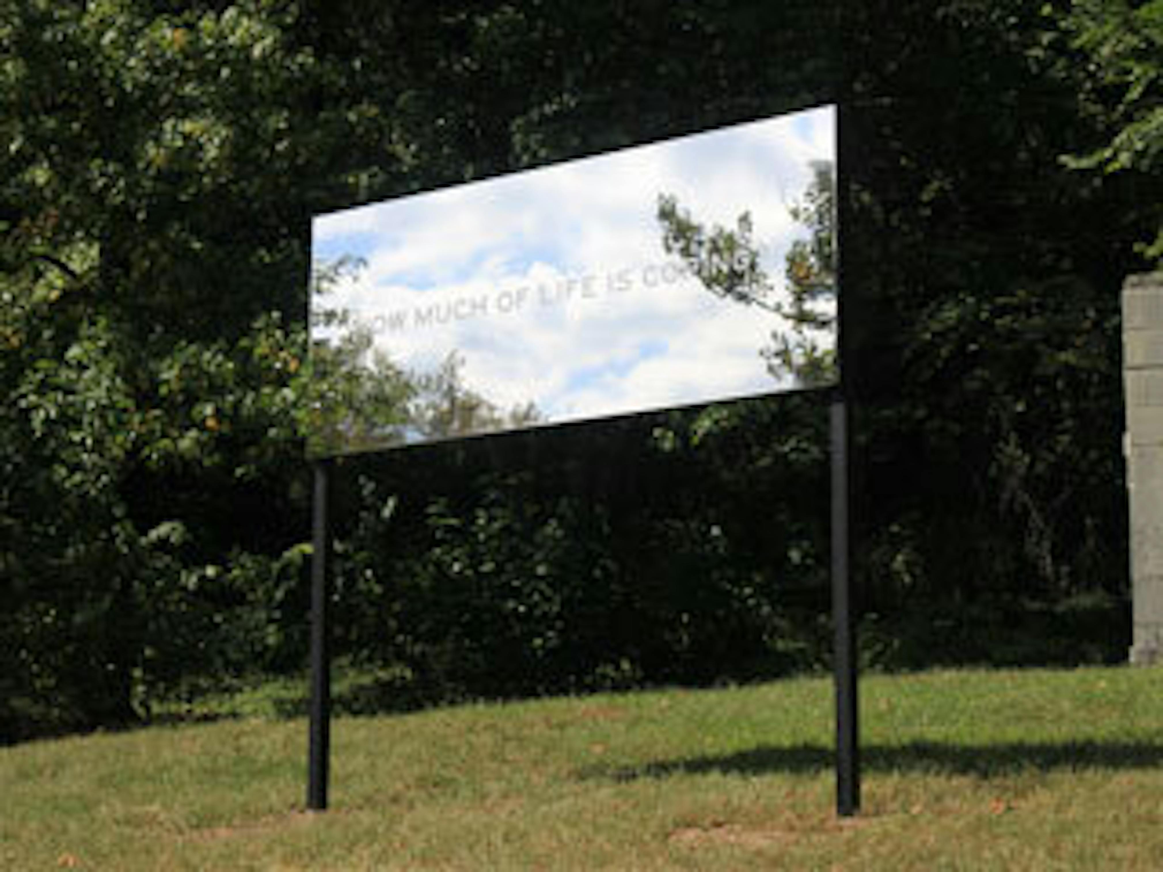 Mirrored billboard that reflects the blue sky and white clouds, and asks "How much of life is coming"