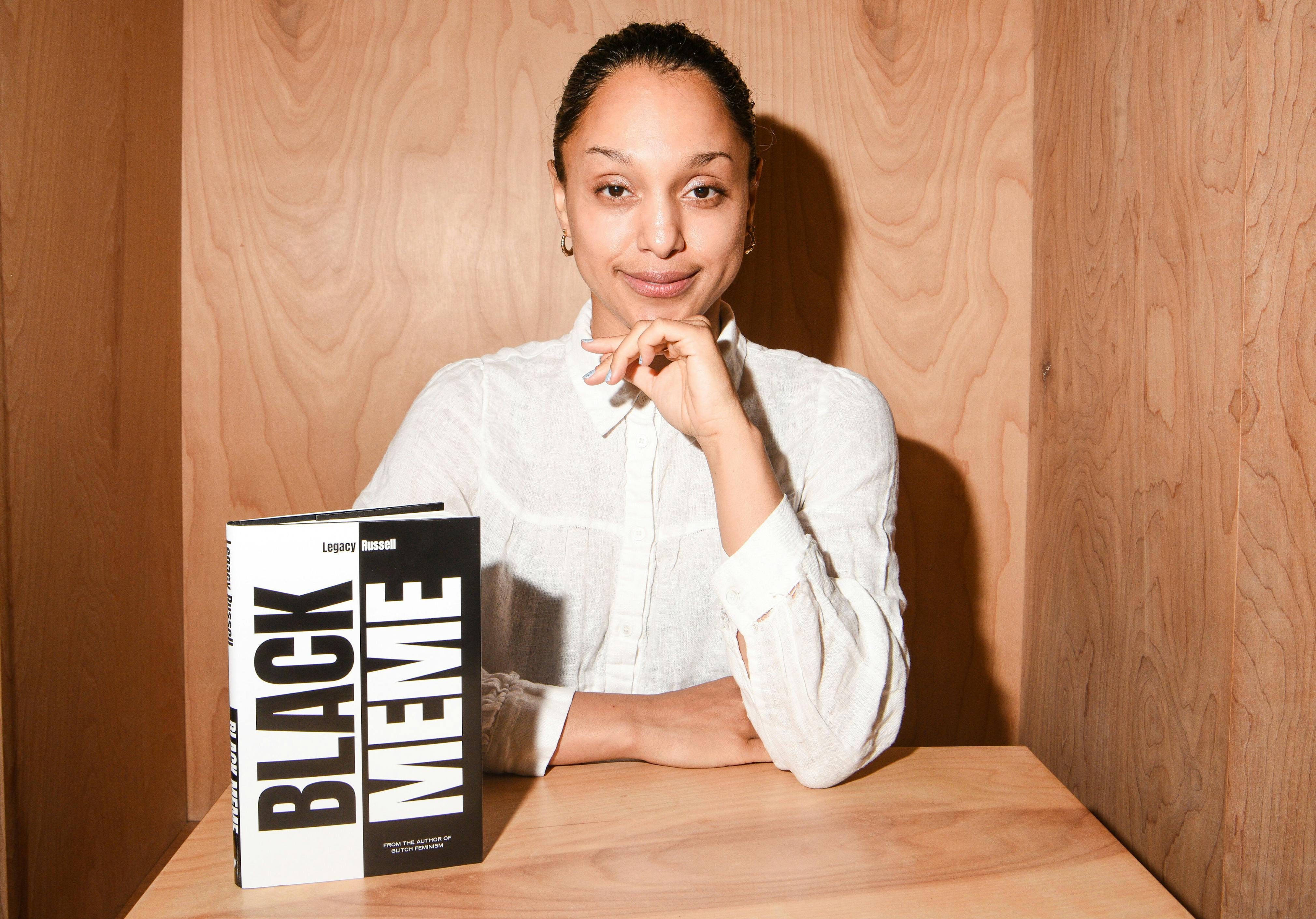 <p>Legacy Russell with her book <em>Black Meme: A History of the Images That Make Us</em> (Verso 2024). Photo: Deonté Lee</p>