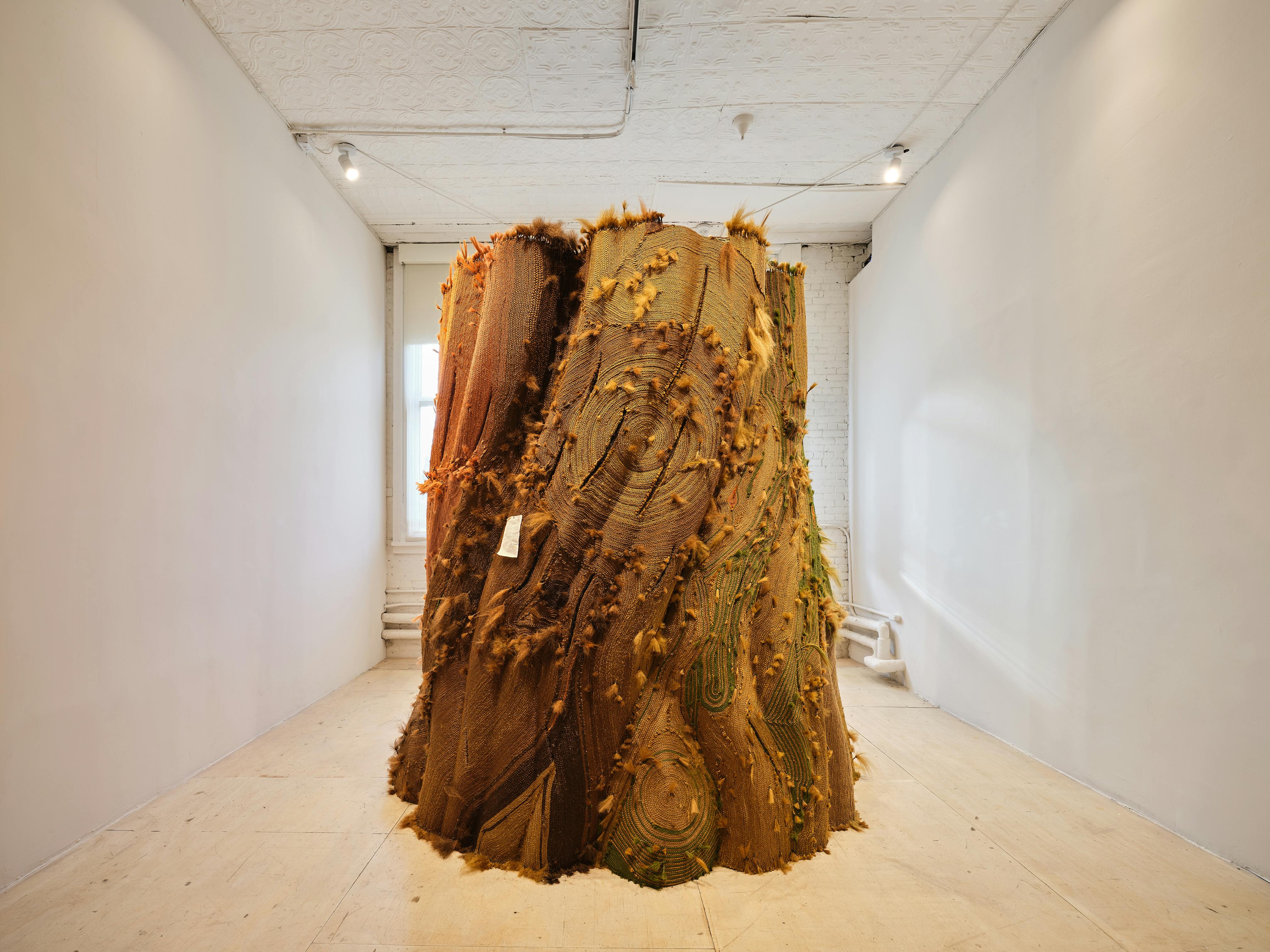 <p>Malcolm Peacock, <em>Five of them were hers and she carved shelters with windows into the backs of their skulls</em>, 2024. Foam, cement-mix overlay, wood, synthetic hair, and six-channel audio (54 min., 38 sec., looped). Installation view of <em>Pass Carry Hold: Studio Museum Artists in Residence 2023–24</em>, on view at MoMA PS1 from September 26, 2024 through February 10, 2025. Photo: Kris Graves</p>