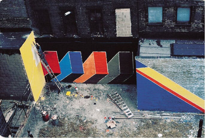Minipark off E. 121st St. (between 2nd and 3rd Aves.) Guy Ciarcia, captured from above, paints a final section of wall. Artwork created by Smokehouse Associates. Courtesy William T. Williams Archives
