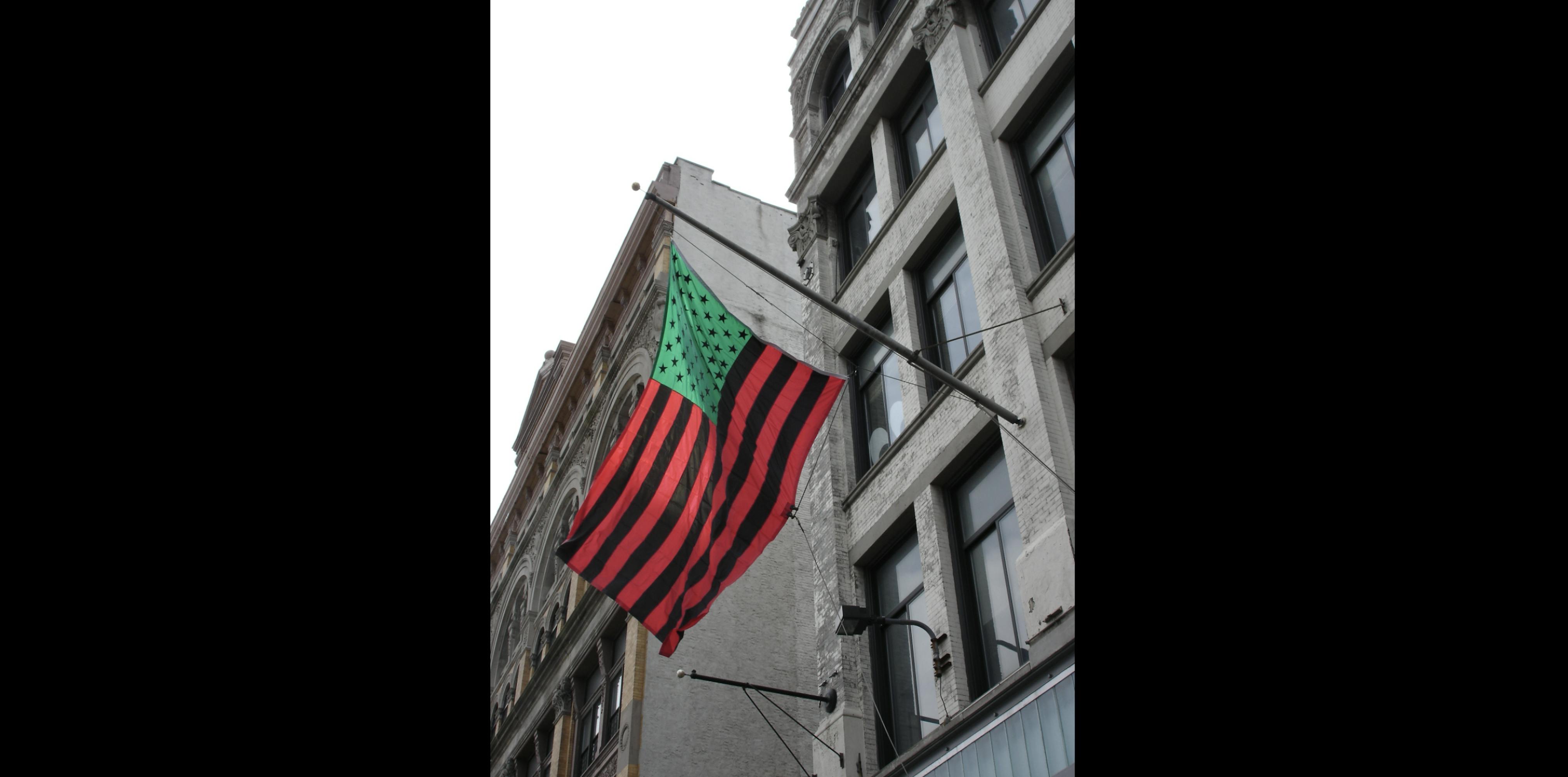<p>David Hammons, <em>Untitled</em> flag (installation view), 2004. Custom appliqued, single-reverse nylon flag (200 denier nylon), 96 × 144 in. Studio Museum in Harlem; gift of the artist  SP.2004.1. Photo: Ray Llanos</p>