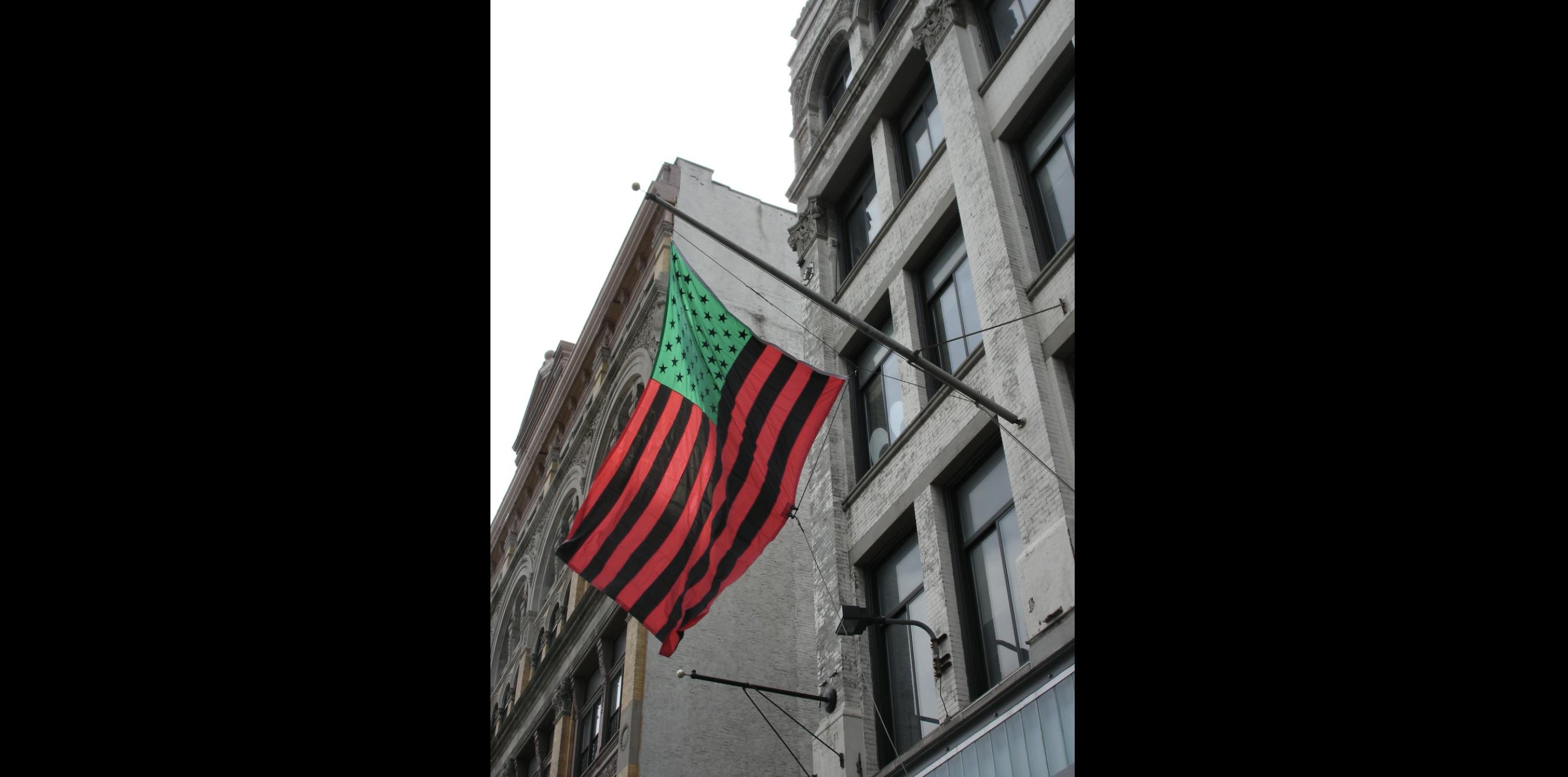 <p>David Hammons, <em>Untitled</em> flag (installation view), 2004. Custom appliqued, single-reverse nylon flag (200 denier nylon), 96 × 144 in. Studio Museum in Harlem; gift of the artist  SP.2004.1. Photo: Ray Llanos</p>