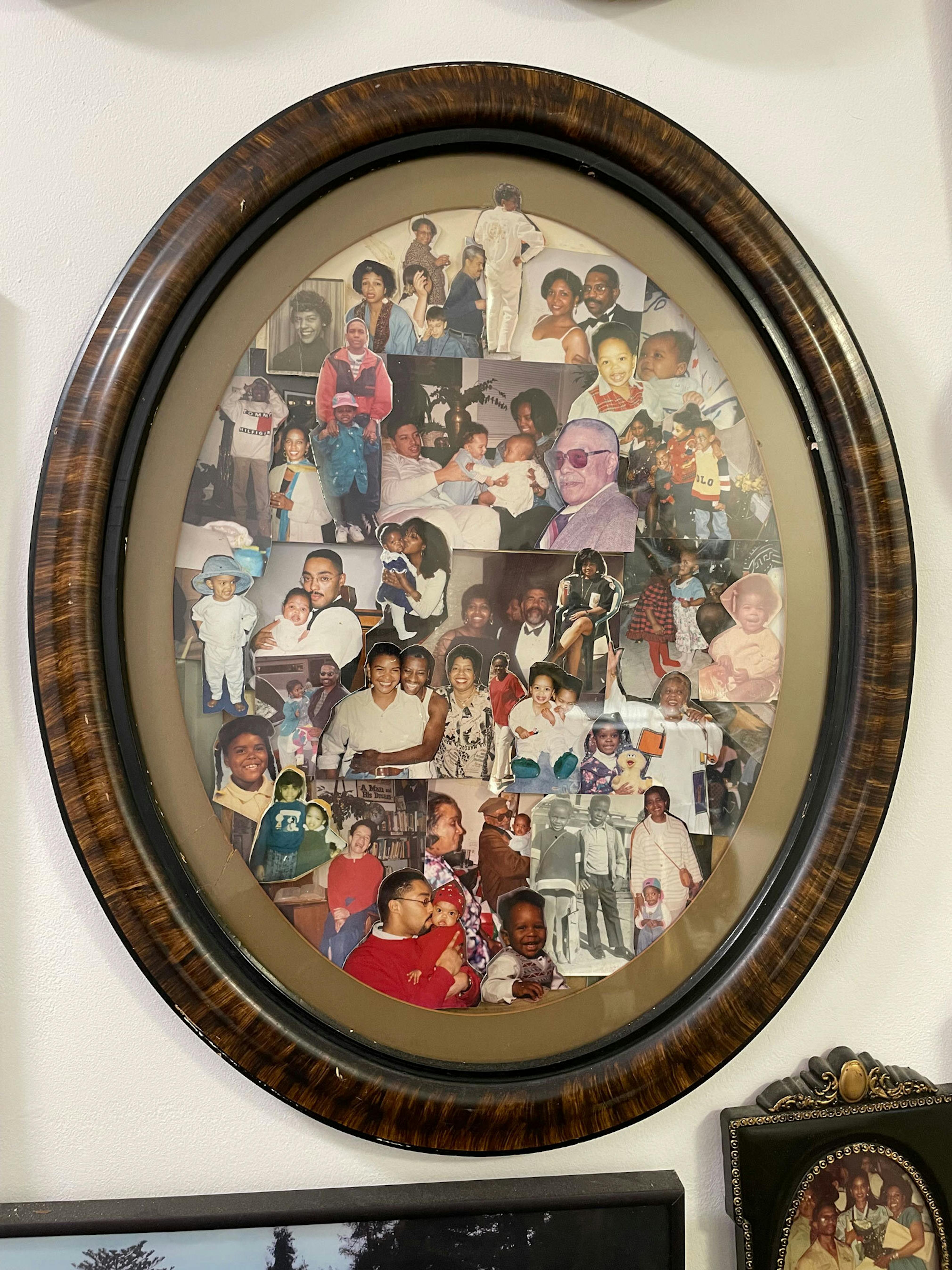 An oval picture frame with a collage of family photos.